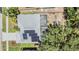 Birds eye view of a house featuring solar panels, a screen patio and a fenced yard at 18013 Palm Breeze Dr, Tampa, FL 33647