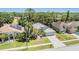 Elevated view of a beautiful home with a well-manicured lawn, solar panels, and mature trees at 18013 Palm Breeze Dr, Tampa, FL 33647