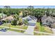 Aerial view of a well-maintained home with solar panels and a large, fenced-in backyard at 18013 Palm Breeze Dr, Tampa, FL 33647