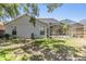 A fenced yard features mature landscaping and a screened lanai, perfect for outdoor gatherings and relaxation at 18013 Palm Breeze Dr, Tampa, FL 33647
