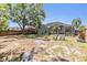 Spacious fenced yard features a large tree, mature landscaping and a screened lanai, perfect for outdoor gatherings and relaxation at 18013 Palm Breeze Dr, Tampa, FL 33647