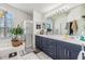 A bright primary bath with double vanity, large mirror, standalone shower, and a garden tub at 18013 Palm Breeze Dr, Tampa, FL 33647