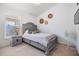 Bedroom with neutral tones, a cozy queen-size bed, and a window for natural light at 18013 Palm Breeze Dr, Tampa, FL 33647