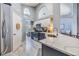Bright kitchen featuring stainless steel appliances, two-tone cabinets, an island with a breakfast bar and wood-look flooring at 18013 Palm Breeze Dr, Tampa, FL 33647