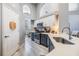 Bright kitchen featuring stainless steel appliances, two-tone cabinets, an island with a breakfast bar and wood-look flooring at 18013 Palm Breeze Dr, Tampa, FL 33647