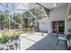 An ample covered lanai overlooking a well maintained yard with a fenced perimeter and beautiful green views at 18013 Palm Breeze Dr, Tampa, FL 33647