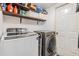 Functional laundry room with a side by side washer and dryer, overhead storage shelf, and a convenient utility door at 18013 Palm Breeze Dr, Tampa, FL 33647