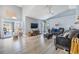 Bright open concept living room area featuring luxury vinyl plank flooring, ceiling fan and a TV at 18013 Palm Breeze Dr, Tampa, FL 33647