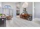 Bright living room with wood floors, piano, and comfortable armchair at 18013 Palm Breeze Dr, Tampa, FL 33647