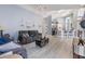 Living room area featuring luxury vinyl plank flooring, ceiling fan, and access to the kitchen at 18013 Palm Breeze Dr, Tampa, FL 33647