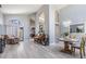 Open-concept living room with wood floors and large windows that let in natural light at 18013 Palm Breeze Dr, Tampa, FL 33647