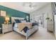 A spacious and well-lit main bedroom features neutral carpet, a statement wall, and access to the patio at 18013 Palm Breeze Dr, Tampa, FL 33647