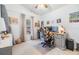 Bright office space featuring a desk with dual monitors, beige carpet and natural light at 18013 Palm Breeze Dr, Tampa, FL 33647