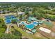 Aerial view of large community clubhouse, pools, playgrounds, tennis courts, and sand volleyball court at 19129 Lake Audubon Dr, Tampa, FL 33647