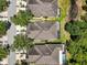 Aerial view of homes with screened in pools, lovely landscaping and a beautiful community pond at 19129 Lake Audubon Dr, Tampa, FL 33647