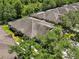 Aerial view of roofs, trees, and the rear lanai areas of a subdivision at 19129 Lake Audubon Dr, Tampa, FL 33647