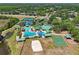 Aerial view of community clubhouse, pools, playgrounds, tennis courts, and sand volleyball court at 19129 Lake Audubon Dr, Tampa, FL 33647