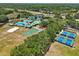 Aerial view of community clubhouse, pools, playgrounds, tennis courts, and sand volleyball court at 19129 Lake Audubon Dr, Tampa, FL 33647