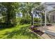 Landscaped backyard view with lush greenery, mature trees, and a screened-in lanai perfect for outdoor relaxation at 19129 Lake Audubon Dr, Tampa, FL 33647