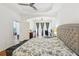 Spacious bedroom with a work area, ceiling fan, and large windows providing ample natural light at 19129 Lake Audubon Dr, Tampa, FL 33647
