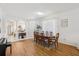 Formal dining room with hardwood floors, a large table, and an open layout to other living areas at 19129 Lake Audubon Dr, Tampa, FL 33647