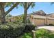 Charming home with a two-car garage, mature landscaping, and a well-maintained lawn at 19129 Lake Audubon Dr, Tampa, FL 33647
