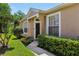 Inviting front entrance with well-manicured landscaping and neutral exterior paint at 19129 Lake Audubon Dr, Tampa, FL 33647