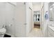 Bright hallway features a bathroom, bedroom access, tile flooring and natural light at 19129 Lake Audubon Dr, Tampa, FL 33647