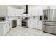 This modern kitchen features stainless steel appliances, sleek white cabinetry and tile flooring at 19129 Lake Audubon Dr, Tampa, FL 33647