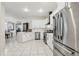 Bright kitchen features stainless steel appliances, white cabinets, sleek hood vent and granite countertops at 19129 Lake Audubon Dr, Tampa, FL 33647