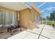 Enclosed lanai with a table, potted plants, and a view of the backyard at 19129 Lake Audubon Dr, Tampa, FL 33647
