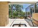 Enclosed lanai with plants, hammock, and shade at 19129 Lake Audubon Dr, Tampa, FL 33647