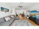 Bright, open-concept living room with a ceiling fan, hardwood floors and ample seating at 19129 Lake Audubon Dr, Tampa, FL 33647