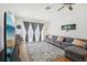 Comfortable living room with a large window, grey couch, and wood-look flooring at 19129 Lake Audubon Dr, Tampa, FL 33647