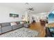 Spacious living room with hardwood floors, a ceiling fan, and access to other rooms at 19129 Lake Audubon Dr, Tampa, FL 33647