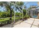 Large screened-in patio with view of lush backyard and a glimpse of the pool at 19129 Lake Audubon Dr, Tampa, FL 33647