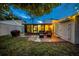 Backyard patio with decorative lights, furniture, grill and view of lush greenery at 20 Windrush Bay Dr # 20, Tarpon Springs, FL 34689
