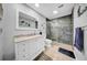 Modern bathroom with a glass enclosed shower, marble countertops and a large mirror at 20 Windrush Bay Dr # 20, Tarpon Springs, FL 34689