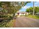 Quaint single-Gathering home with a red front door and well-kept landscaping at 20 Windrush Bay Dr, Tarpon Springs, FL 34689