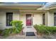 Inviting front entrance with a red door and manicured landscaping at 20 Windrush Bay Dr # 20, Tarpon Springs, FL 34689
