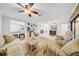 Expansive living area with seating, large ceiling fans and lots of natural light at 20 Windrush Bay Dr # 20, Tarpon Springs, FL 34689