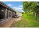 Cozy covered patio features seating and a lush backyard view at 20 Windrush Bay Dr # 20, Tarpon Springs, FL 34689