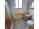 Modest bathroom features unique tiling, vanity, tub and toilet at 2015 Dolphin S Blvd, St Petersburg, FL 33707