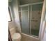 Modest bathroom features a tile shower, grab bar and toilet at 2015 Dolphin S Blvd, St Petersburg, FL 33707