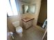 Modest bathroom features unique tiling, vanity and toilet at 2015 Dolphin S Blvd, St Petersburg, FL 33707