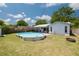 Backyard with pool, patio, and well-maintained lawn, surrounded by a wooden fence for added privacy at 2153 Catalina N Dr, Clearwater, FL 33763