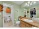 Well-lit bathroom with a wood-finished vanity and walk-in closet at 2153 Catalina N Dr, Clearwater, FL 33763