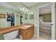 Well-lit bathroom with a wood-finished vanity and walk-in closet at 2153 Catalina N Dr, Clearwater, FL 33763