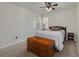 Bedroom features carpet, ceiling fan, and windows with a chest at the foot of the bed at 2153 Catalina N Dr, Clearwater, FL 33763