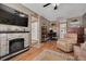 Bonus room showcasing a stone fireplace, TV, and a doorway to another room with laundry area at 2153 Catalina N Dr, Clearwater, FL 33763